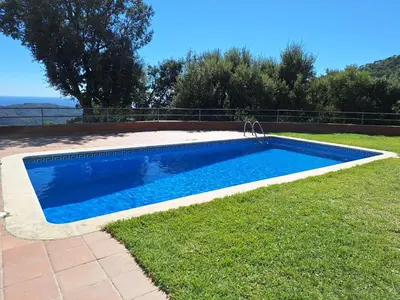 a swimming pool in the yard of a house at Casa Roure-4BR-Piscina privada-BBQ-Vistas Mar in Sant Cebrià de Vallalta