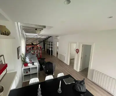 a living room with a black table and chairs at House in Sant Cugat, 25 Mins to Barcelona center in Sant Cugat del Vallès