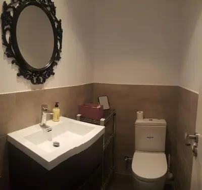 a bathroom with a sink and a toilet and a mirror at House in Sant Cugat, 25 Mins to Barcelona center in Sant Cugat del Vallès