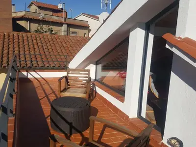 a balcony with a bench and a chair on a house at House in Sant Cugat, 25 Mins to Barcelona center in Sant Cugat del Vallès