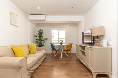 a living room with a couch and a table at Picasso Suites Cornellá in Cornellà de Llobregat