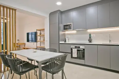 a kitchen and dining room with a table and chairs at Anton's Downtown Apartment in Barcelona