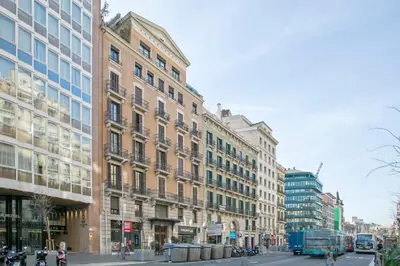 a city street with tall buildings and a blue truck at Anton's Downtown Apartment in Barcelona