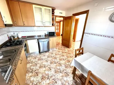 a kitchen with a sink and a stove top oven at Amplio Apartamento, 5 camas in Sant Esteve Sesrovires