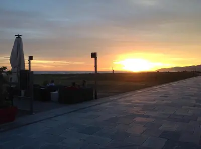 a sunset with the sun setting in the distance at Lets Holidays Castelldefels Diagonal Orient in Castelldefels
