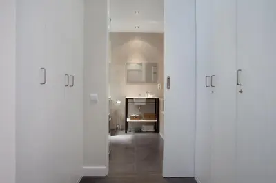 a hallway with white doors in a room at Consell de Cent Apartment in Barcelona