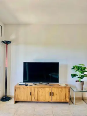 a living room with a large flat screen tv at Apartment in front of the beach in Castelldefels