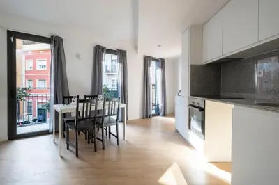 a kitchen and dining room with a table and chairs at StayCampNou 3BR With Balcony in Hospitalet de Llobregat