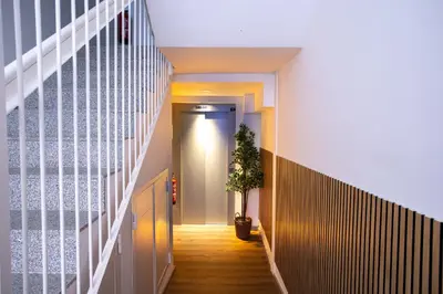 a hallway with a potted plant on the floor at StayCampNou 3BR With Balcony in Hospitalet de Llobregat