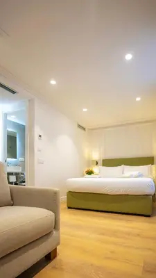 a bedroom with a large bed and a couch at Casa Pince in Barcelona