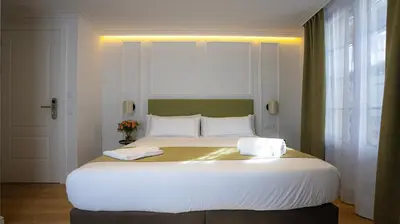 a large white bed in a room with a window at Casa Pince in Barcelona
