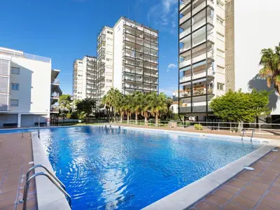 an empty swimming pool in the middle of buildings at Apartment Cortijo Barques by Interhome in Sitges