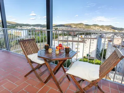 a table and chairs on a balcony with a view at Apartment Cortijo Barques by Interhome in Sitges
