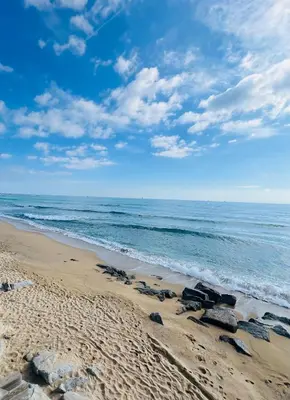a beach with rocks on the sand and the ocean at Apartamento Luna in Montgat