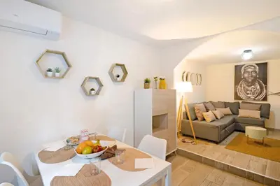 a kitchen and living room with a table and chairs at Apartamento Luna in Montgat