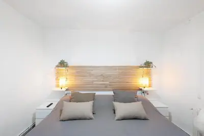 a bedroom with a large bed with two pillows at Apartamento Luna in Montgat