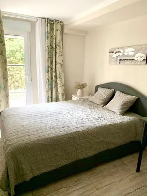 a bedroom with a large bed with a window at Puig comfort in Calella