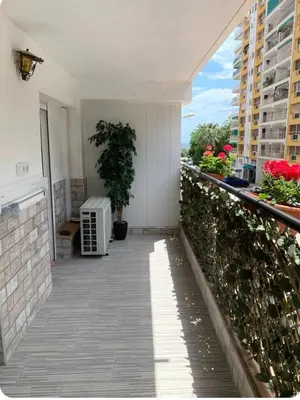 a balcony of a building with a plant on it at Puig comfort in Calella