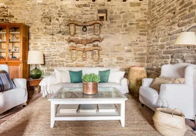 a living room with a couch and a table at Masía espectacular cerca de Barcelona in Granera