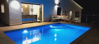 a bedroom with a large bed with white sheets and pillows at Villa privada para grupos grandes cerca de Sitges Piscina terrazas y naturaleza in Olivella