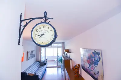 a clock hanging from a wall in a room at Touch the Sky in Hospitalet de Llobregat