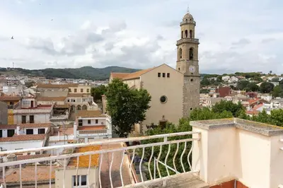 a view of a city with a clock tower at Niu d'Oreneta in Canet de Mar
