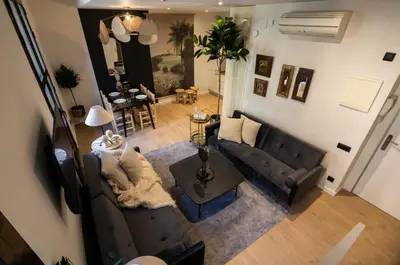 an overhead view of a living room with a couch and a table at En Ville Boutique Apartments Tamarit in Barcelona