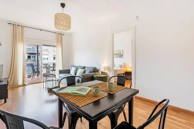 a living room with a table and chairs at Sunny 3BR for 4 Iconic Terrace Views in Barcelona