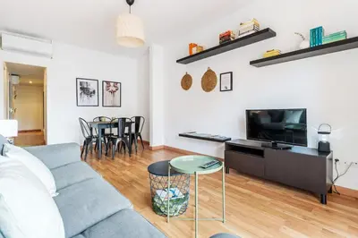 a living room with a couch and a tv at Sunny 3BR for 4 Iconic Terrace Views in Barcelona