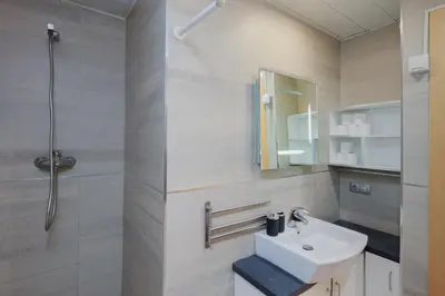 a bathroom with a white sink and a shower at Matarolux27 in Mataró