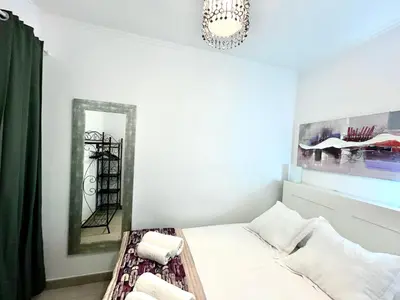 a bedroom with a bed and a chandelier at Apartment Sagrera in Barcelona