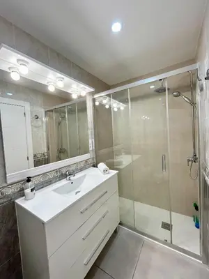 a bathroom with a white sink and a shower at Apartment Sagrera in Barcelona