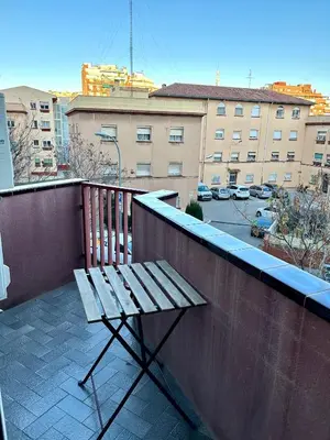 a wooden bench sitting on top of a balcony at Apartment Sagrera in Barcelona