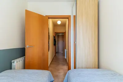 two beds in a room with a hallway at AB Sagrada Familia - Sant Pau in Barcelona