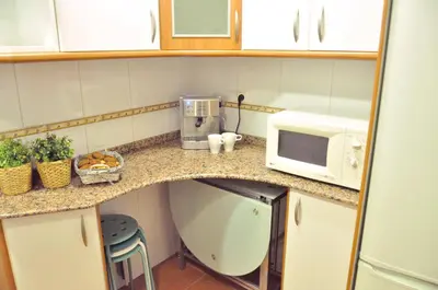 a kitchen with a counter top with a microwave at Chic & Cheap in Barcelona
