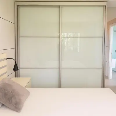 a bedroom with a bed and a sliding glass door at Apartamento en la playa de Castelldefels ( Barcelona) in Castelldefels