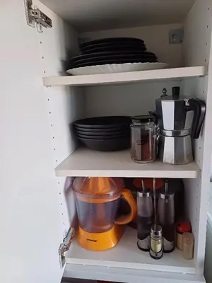 a cupboard filled with dishes and utensils at Apartamento entero en la montaña in El Pont de Vilomara