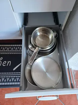 two pots and pans are inside of a drawer at Apartamento entero en la montaña in El Pont de Vilomara