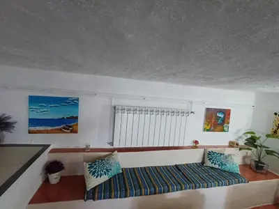 a living room with a couch and a window at Apartamento entero en la montaña in El Pont de Vilomara