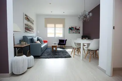 a living room with a couch and a table at Charming & Quiet Park Guell Apartment in Barcelona