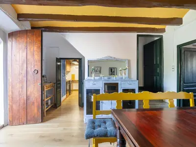 a dining room with a table and a mirror at Can Teulera in San Martín Sarroca