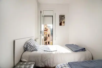 a bedroom with two beds and a window at Holiday home Splendid Park Güell in Barcelona
