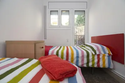 two twin beds in a room with a window at Holiday home Splendid Park Güell in Barcelona