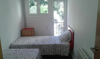 a small bedroom with a bed and a window at Holiday home Splendid Park Güell in Barcelona