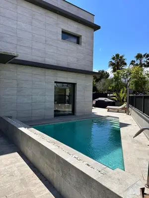 a swimming pool in front of a house at Shome in Vilanova i la Geltrú
