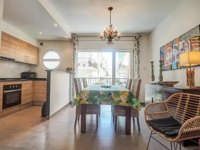 a kitchen with a table and chairs in a kitchen at Zafiro Apartment by Hello Homes Sitges in Sitges