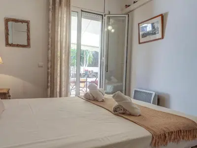 a bedroom with a bed with towels on it at Zafiro Apartment by Hello Homes Sitges in Sitges