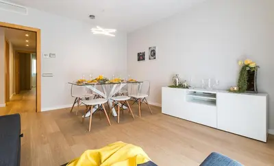 a kitchen and dining room with a table and chairs at Top family apartment by Lofties in Terrassa