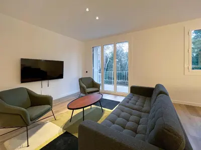 a living room with a couch and two chairs and a tv at Stay U-nique Apartments Putxet in Barcelona