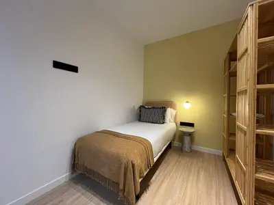 a small bedroom with a bed and a book shelf at Stay U-nique Apartments Putxet in Barcelona
